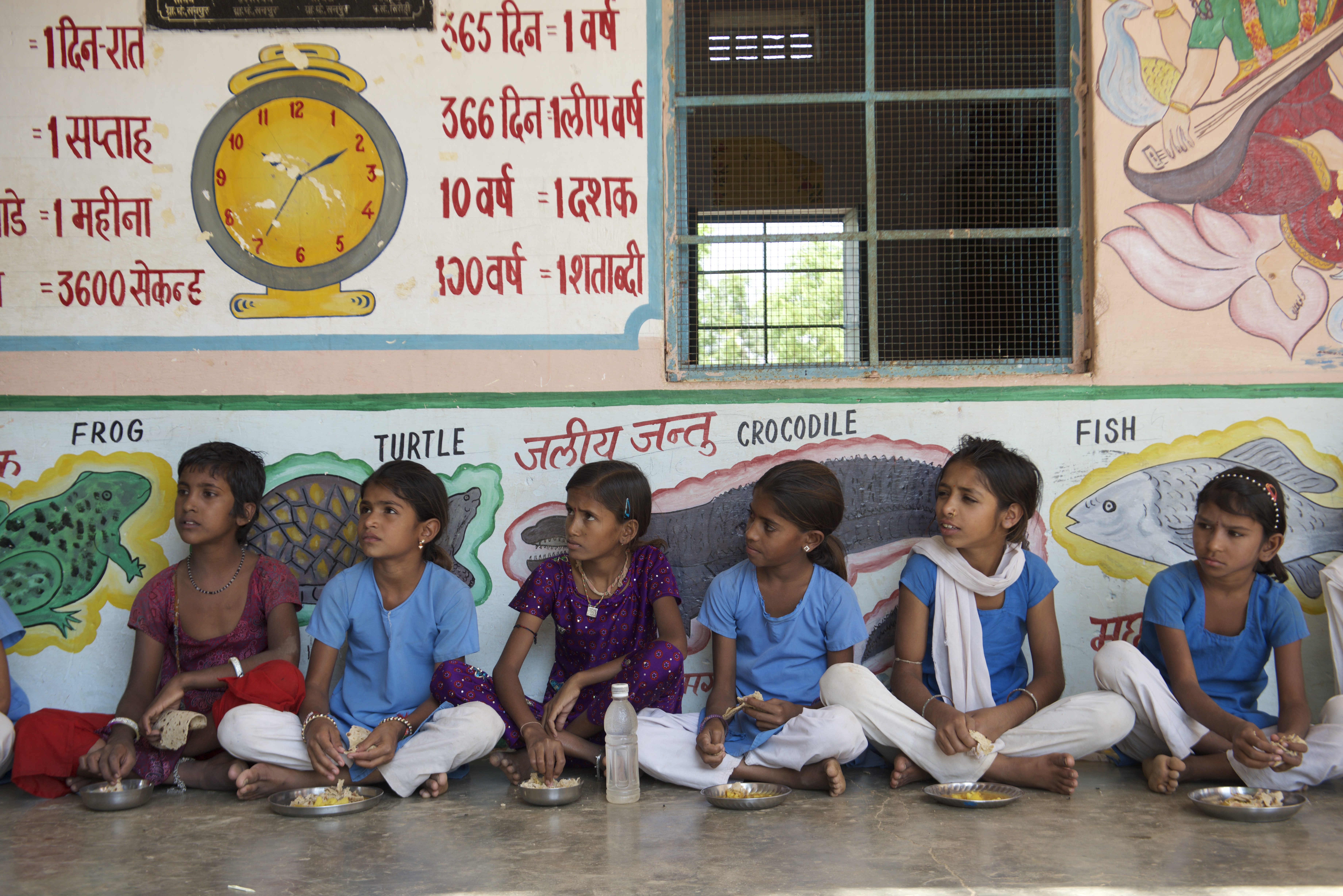 Young girls eating their midday meal at school