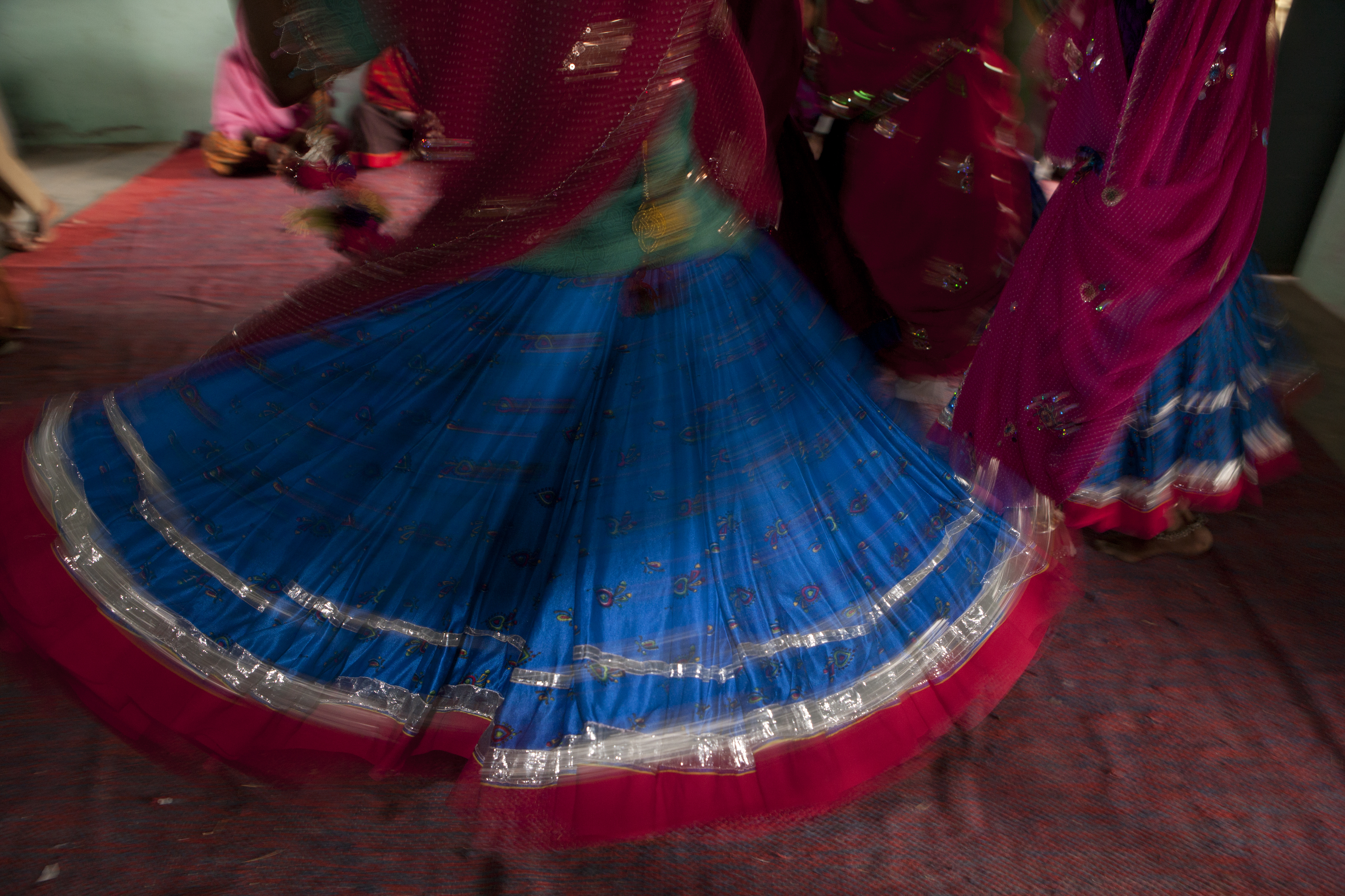 Traditional Rajasthani Skirts swirling at a celebration by Mark Tuschman