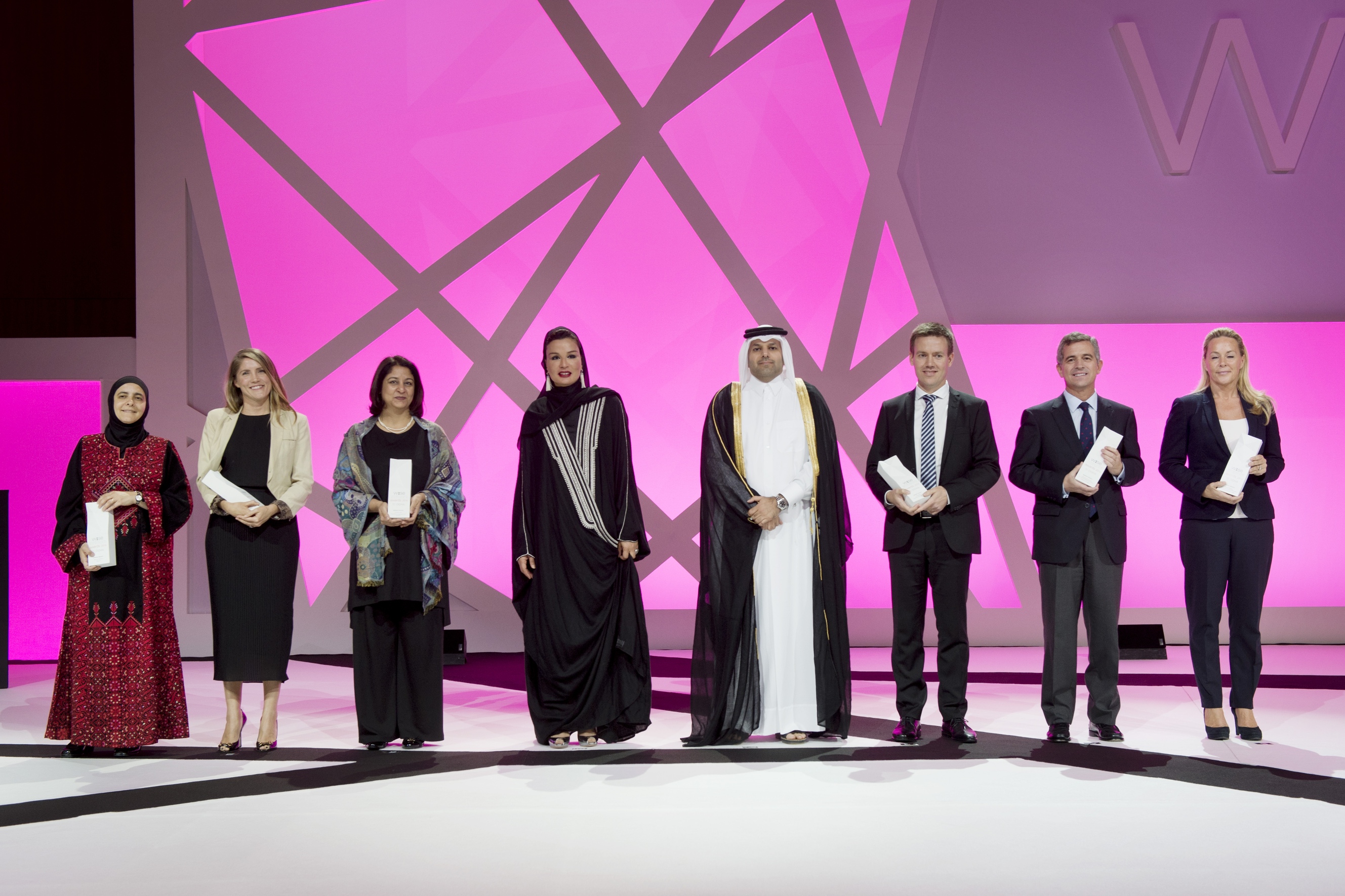 Her Highness Sheikha Moza bint Nasser at the World Innovation Summit for Education (WISE) 2014 gala dinner with Chairman of WISE, His Excellency Dr. Sheikh Abdullah bin Ali Al-Thani, and the six award-winners.